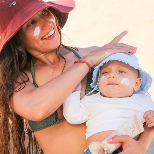 Kids Mineral Sunscreen SPF 30 - Woman Applying Formula On Her Child On the Beach Happy - Suntribe Reef Safe Sunscreen-1 (2)