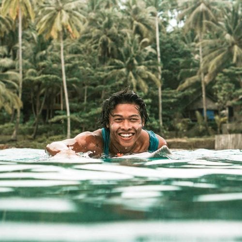 Zinc White - Man paddling surfing in indonesia - Suntribe Reef Safe Mineral Sunscreen @Marjos_Stories (2)